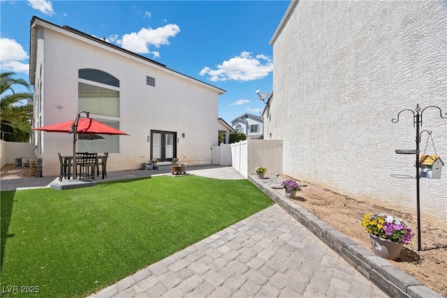 10342 Cherry Brook St, Las Vegas, NV 89183 - back of property with a lawn, a fenced backyard, stucco siding, and a patio area