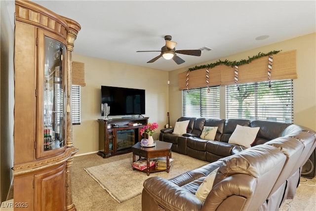 living area with ceiling fan, light carpet, and visible vents