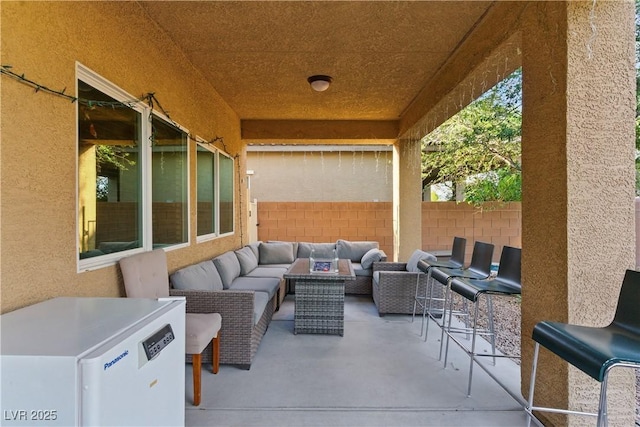 view of patio with fence and outdoor lounge area