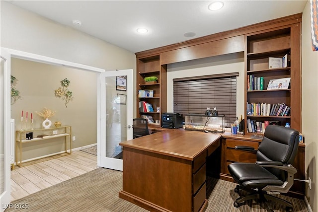 office featuring baseboards, built in shelves, and french doors