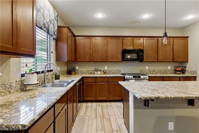 kitchen featuring a sink, pendant lighting, brown cabinetry, and stainless steel appliances