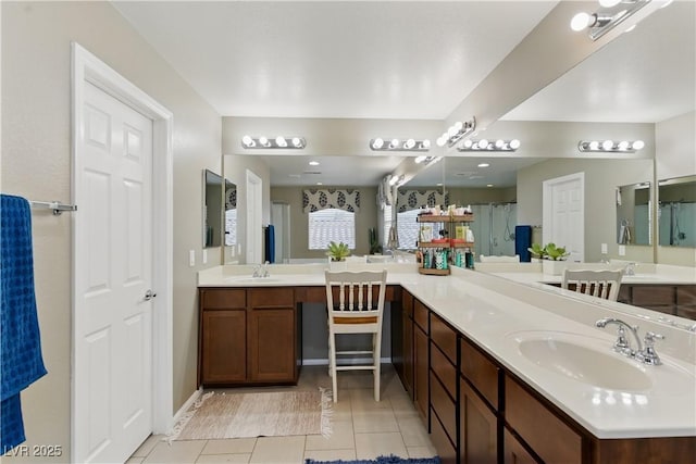full bath featuring vanity, tile patterned flooring, and walk in shower