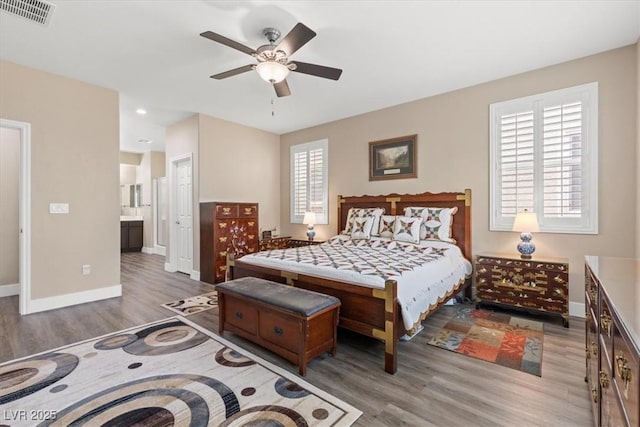 bedroom with ceiling fan, baseboards, visible vents, and wood finished floors
