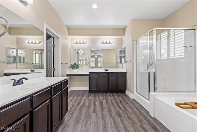 bathroom featuring a sink, a shower stall, and a healthy amount of sunlight