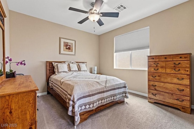 carpeted bedroom with visible vents, baseboards, and ceiling fan