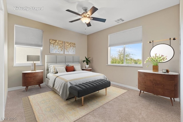 carpeted bedroom featuring ceiling fan, baseboards, and visible vents