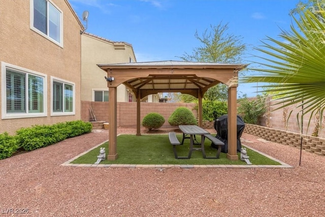 view of yard with a fenced backyard, a gazebo, and a patio area