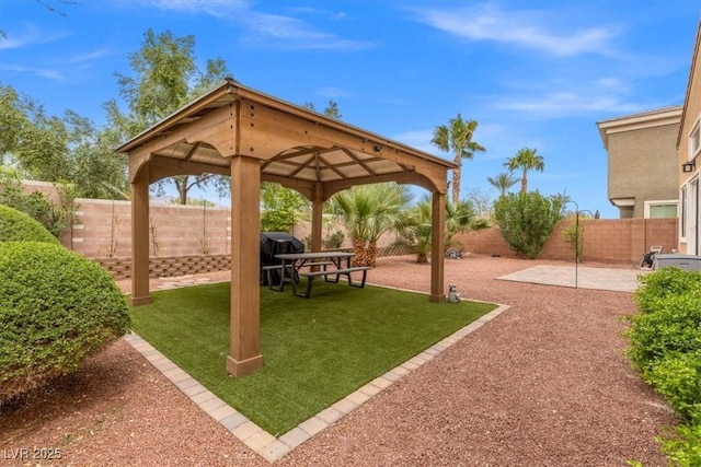 exterior space with a yard, a gazebo, a patio area, and a fenced backyard