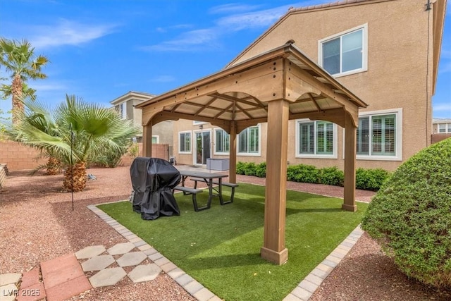 exterior space featuring a gazebo, area for grilling, and fence