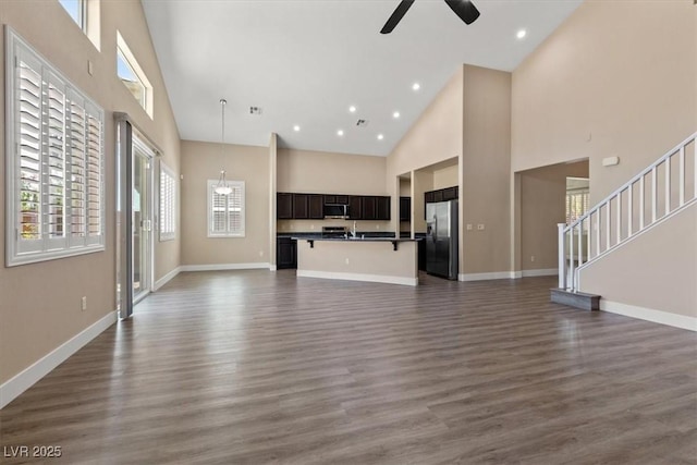 4212 Hawks Glide Ave, North Las Vegas, NV 89084 - unfurnished living room with high vaulted ceiling, a ceiling fan, plenty of natural light, dark wood finished floors, and recessed lighting