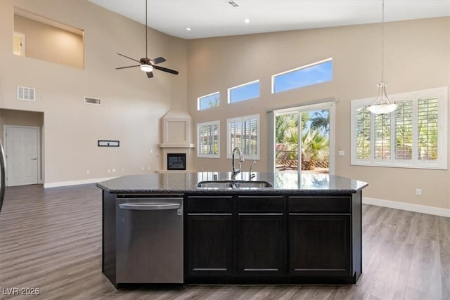 4212 Hawks Glide Ave, North Las Vegas, NV 89084 - kitchen with stainless steel dishwasher, open floor plan, a high ceiling, dark stone countertops, and dark cabinets