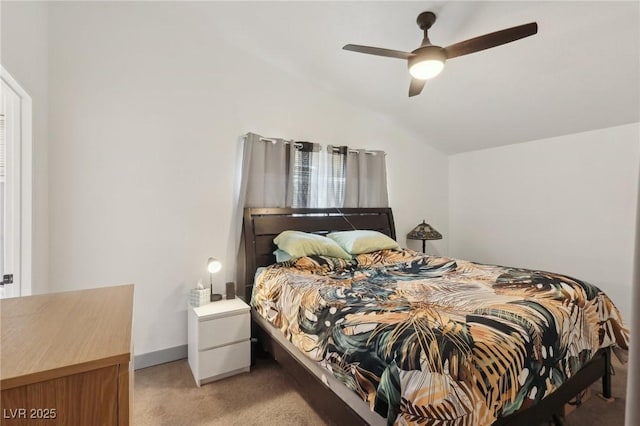 bedroom featuring baseboards, light colored carpet, ceiling fan, and vaulted ceiling