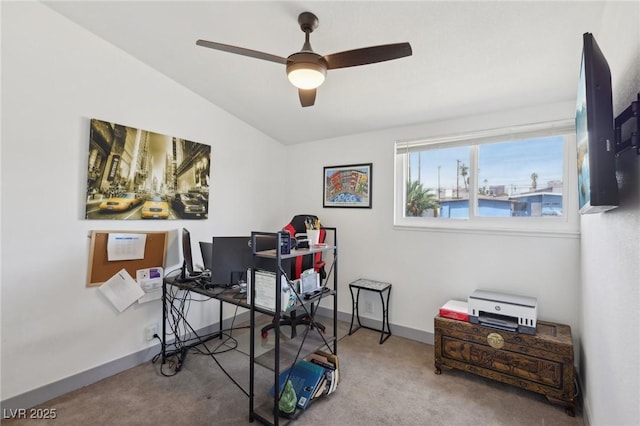 carpeted home office with ceiling fan and baseboards