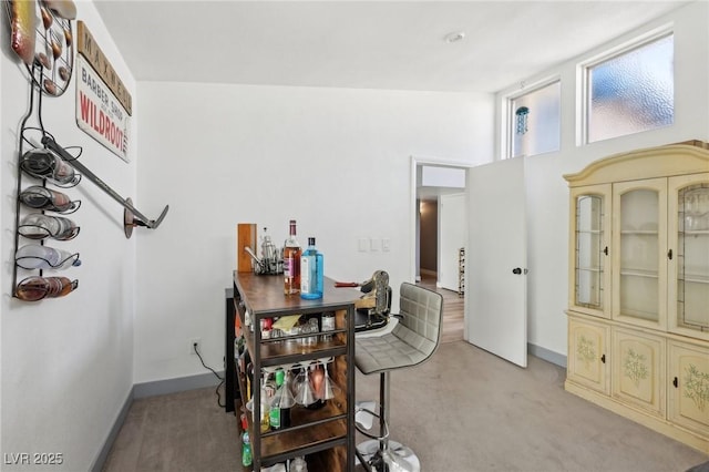 dining area with light colored carpet and baseboards