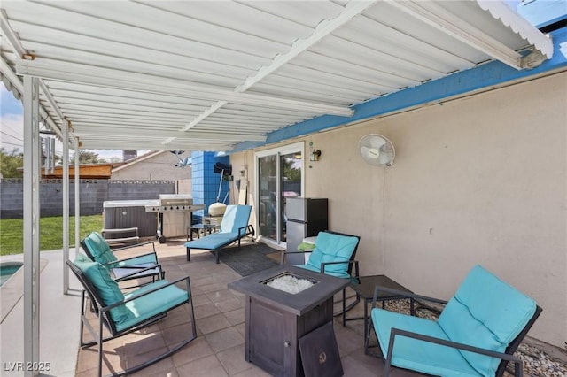 view of patio featuring an outdoor fire pit and fence