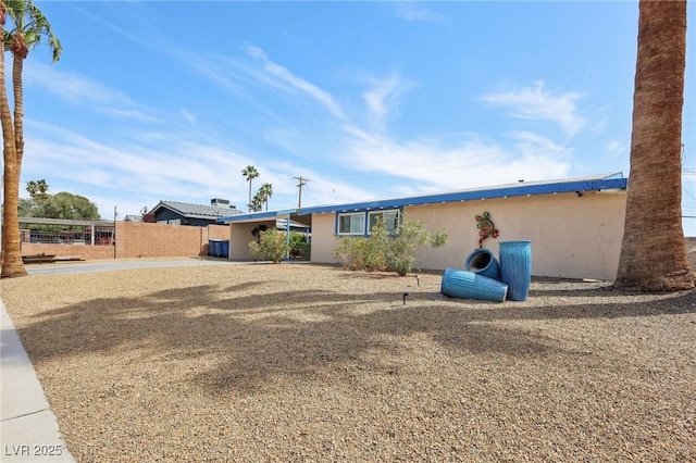 exterior space with fence and stucco siding