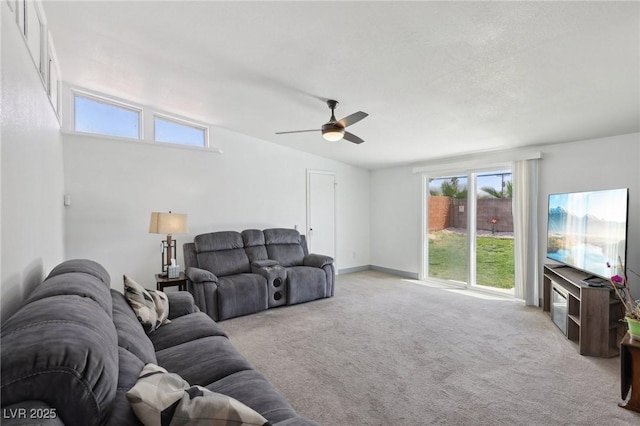 carpeted living room featuring a ceiling fan