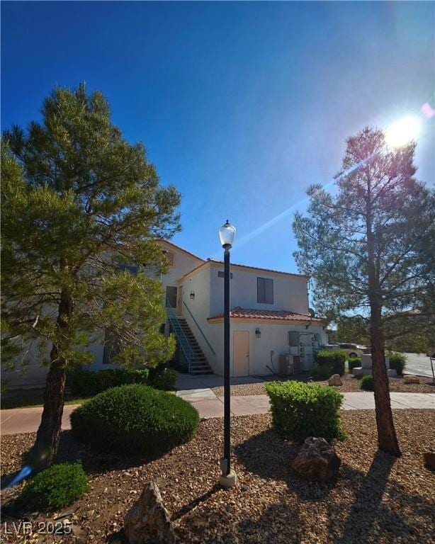 8452 Boseck Dr Unit 216, Las Vegas, NV 89145 - view of home's exterior with stairway and stucco siding