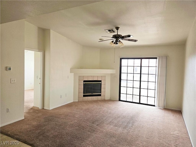8452 Boseck Dr Unit 216, Las Vegas, NV 89145 - unfurnished living room with a ceiling fan, carpet floors, a tiled fireplace, and baseboards