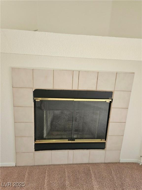 8452 Boseck Dr Unit 216, Las Vegas, NV 89145 - detailed view of carpet floors and a tiled fireplace