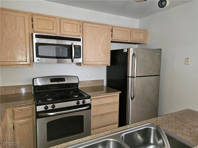 8452 Boseck Dr Unit 216, Las Vegas, NV 89145 - kitchen with stainless steel appliances, light brown cabinets, and dark countertops