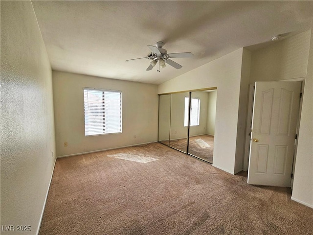 8452 Boseck Dr Unit 216, Las Vegas, NV 89145 - unfurnished bedroom with carpet, vaulted ceiling, a closet, baseboards, and a ceiling fan