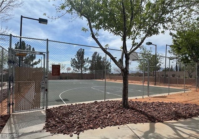 view of sport court with community basketball court, fence, and a gate