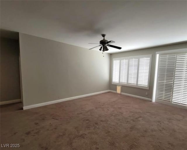 carpeted empty room with baseboards and a ceiling fan