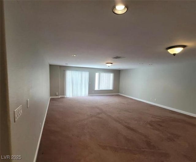 carpeted empty room with visible vents and baseboards