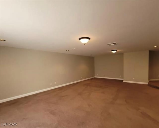 carpeted empty room featuring visible vents and baseboards