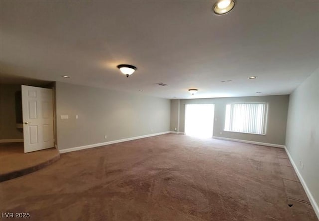carpeted empty room featuring baseboards and recessed lighting