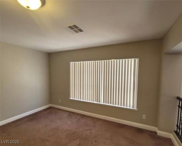 unfurnished room featuring visible vents, baseboards, and carpet floors