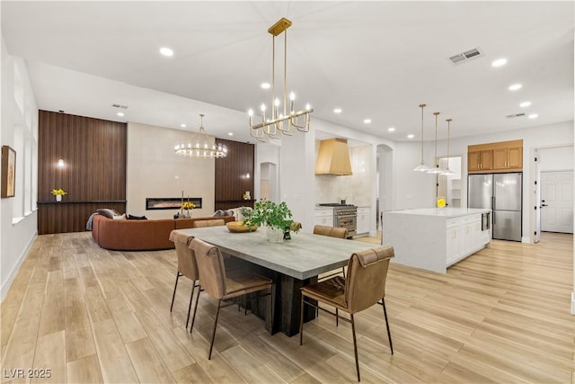 800 Jody Brook Ct, Las Vegas, NV 89145 - dining room with light wood-style floors, recessed lighting, arched walkways, and a chandelier
