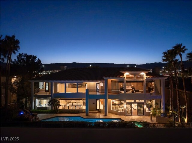 5020 Spanish Heights Dr, Las Vegas, NV 89148 - rear view of property featuring a balcony, an outdoor pool, a patio, and metal roof