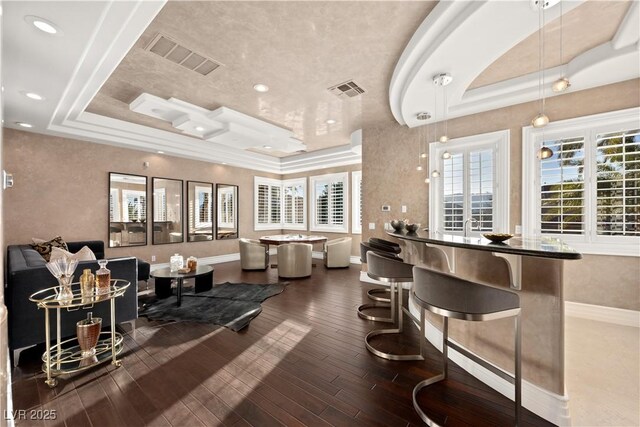 5020 Spanish Heights Dr, Las Vegas, NV 89148 - bar featuring a tray ceiling, baseboards, wood finished floors, recessed lighting, and pendant lighting