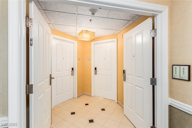 145 E Harmon Ave Unit 2019, Las Vegas, NV 89109 - interior space featuring a paneled ceiling, light tile patterned floors, and baseboards