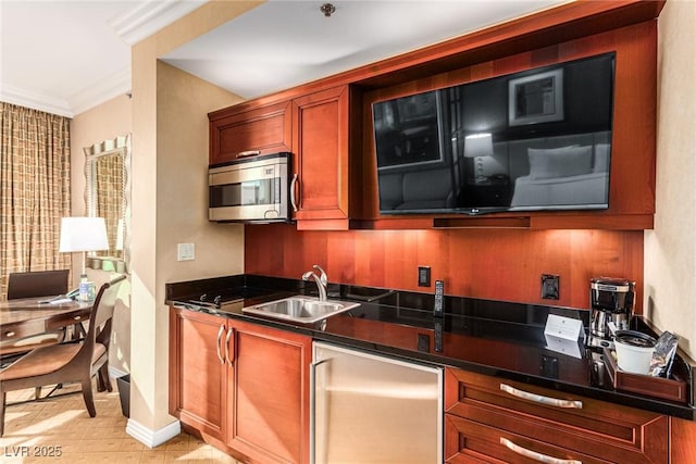 145 E Harmon Ave Unit 2019, Las Vegas, NV 89109 - kitchen with a sink, ornamental molding, dark countertops, stainless steel microwave, and fridge