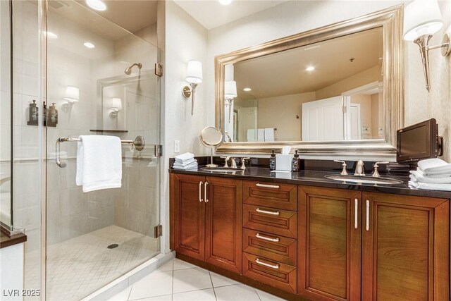 145 E Harmon Ave Unit 2019, Las Vegas, NV 89109 - bathroom with a shower stall, tile patterned floors, double vanity, and a sink
