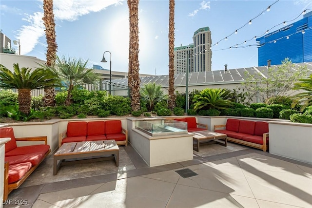 145 E Harmon Ave Unit 2019, Las Vegas, NV 89109 - view of patio / terrace with outdoor lounge area and fence