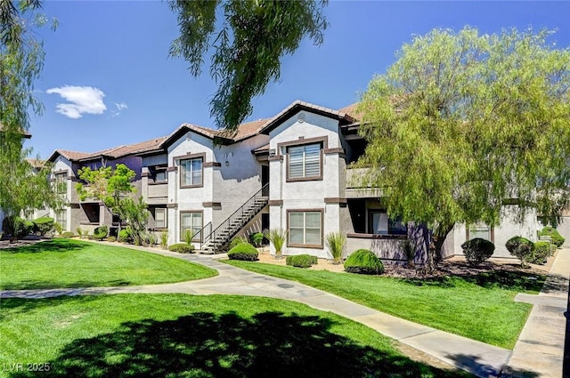 view of front of house with a front lawn and stucco siding