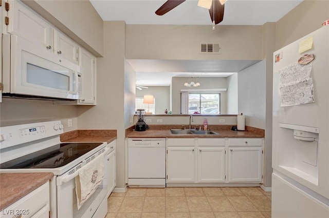 kitchen featuring ceiling fan with notable chandelier, white appliances, white cabinets, visible vents, and a sink