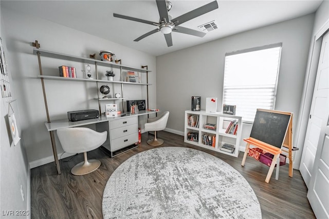 office space featuring dark wood-style flooring, visible vents, ceiling fan, and baseboards