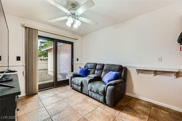 living area featuring ceiling fan, baseboards, and light tile patterned floors