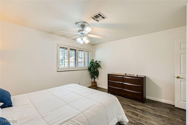 bedroom featuring baseboards, a ceiling fan, wood finished floors, and visible vents