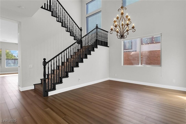 2805 Proust Ct, Henderson, NV 89044 - stairway featuring wood finished floors, a chandelier, and a high ceiling