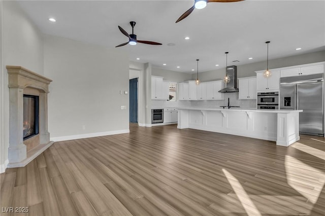 2805 Proust Ct, Henderson, NV 89044 - unfurnished living room with ceiling fan, a fireplace, recessed lighting, and light wood-style flooring
