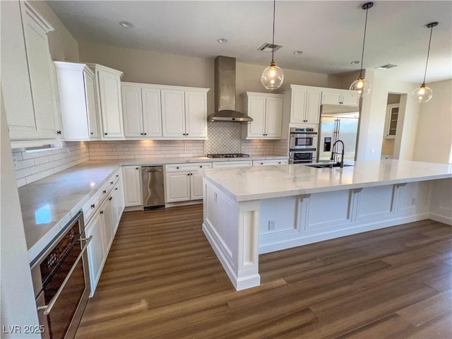 2805 Proust Ct, Henderson, NV 89044 - kitchen featuring wall chimney exhaust hood, appliances with stainless steel finishes, white cabinets, dark wood-style floors, and tasteful backsplash