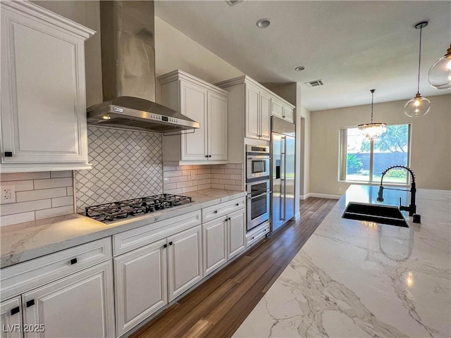 2805 Proust Ct, Henderson, NV 89044 - kitchen featuring appliances with stainless steel finishes, wall chimney exhaust hood, white cabinetry, and tasteful backsplash