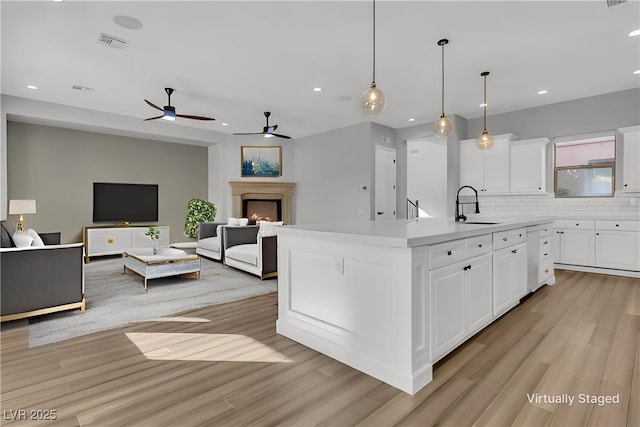 2805 Proust Ct, Henderson, NV 89044 - kitchen featuring light wood-type flooring, recessed lighting, white cabinets, decorative backsplash, and ceiling fan