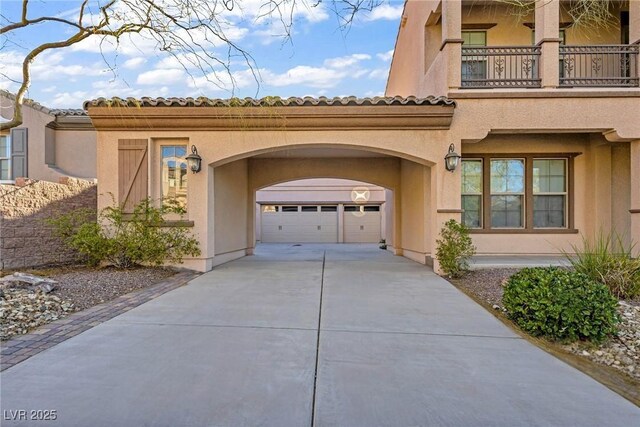 2805 Proust Ct, Henderson, NV 89044 - view of front facade with driveway, a garage, stucco siding, and a tile roof